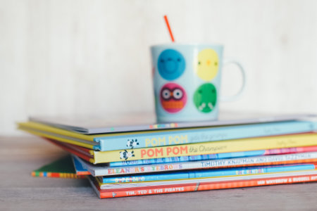 Stack of books with a mug on top